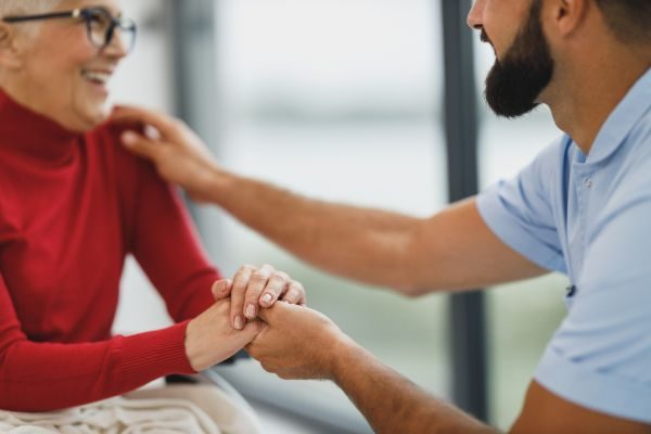 A caregiver supporting an older adult