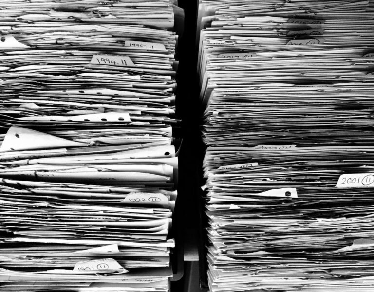 Stacks of paper files ready for filing